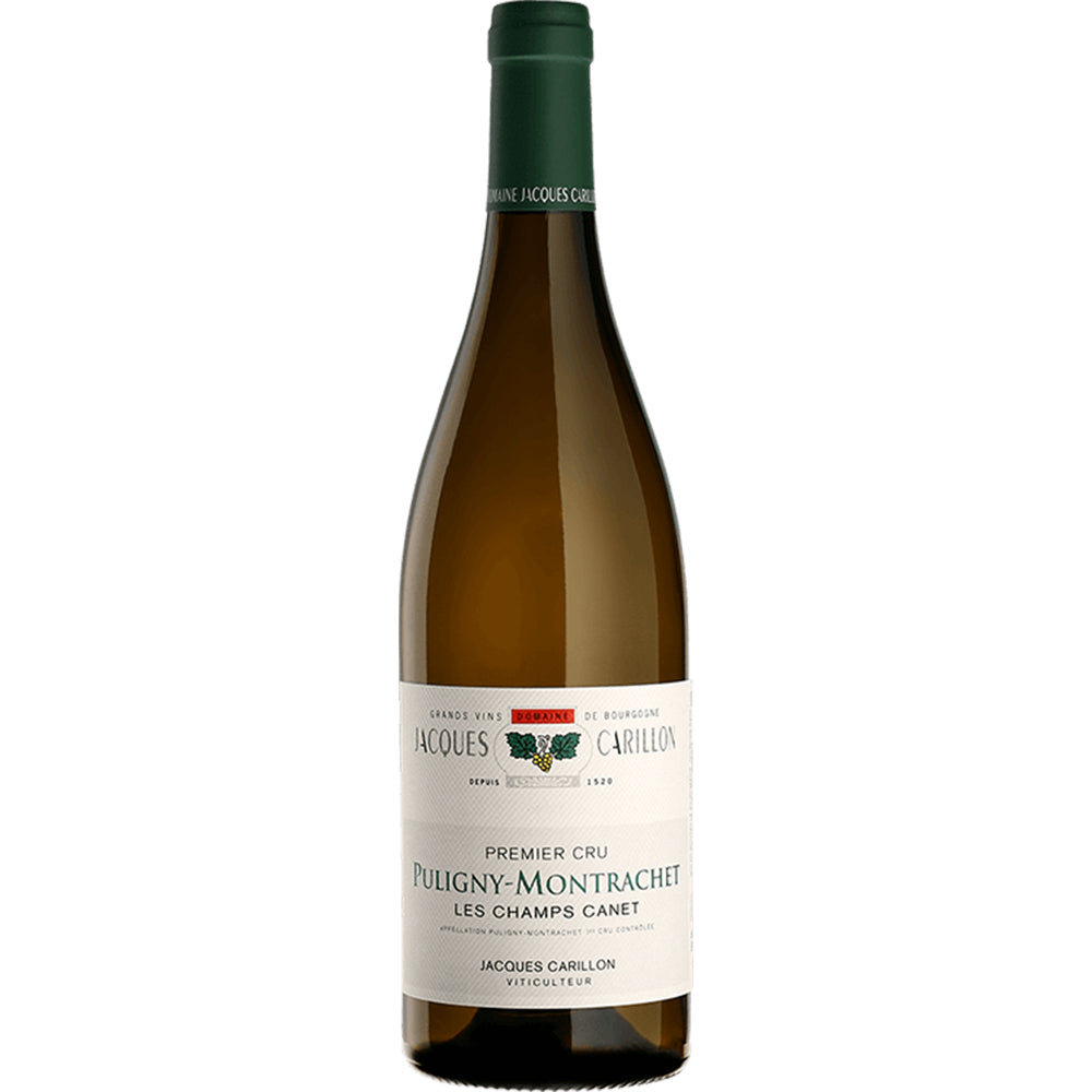 A bottle of Jacques Carillon - Puligny-Montrachet - Les Champs Canet wine, showcasing a deep green neck and a white label adorned with imagery of the vineyard and text that details its vintage and origin.