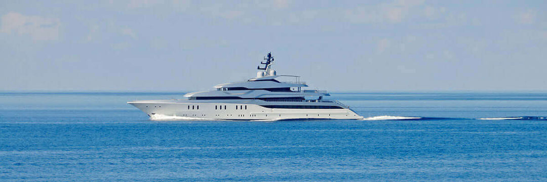A superyacht under way on calm Mediterranean water
